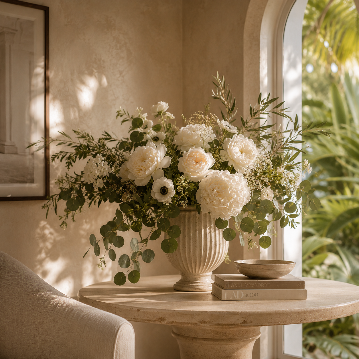 A finished white floral arrangement in a sunlit room